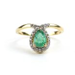 A 9ct yellow gold ring set teardrop emerald in a border of small diamonds by Jacques Christie,