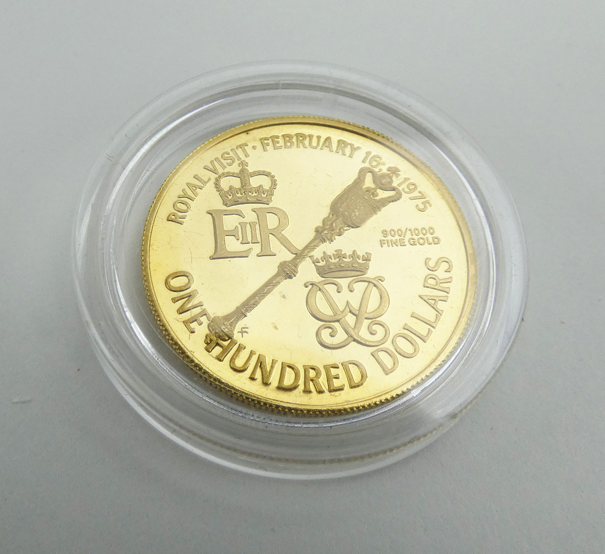 A 22ct yellow gold $100 coin commemorating the Royal visit to Bermuda in 1975,