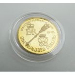 A 22ct yellow gold $100 coin commemorating the Royal visit to Bermuda in 1975,