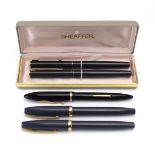 A cased pair of Sheaffer fountain pens together with three further Sheaffer pens