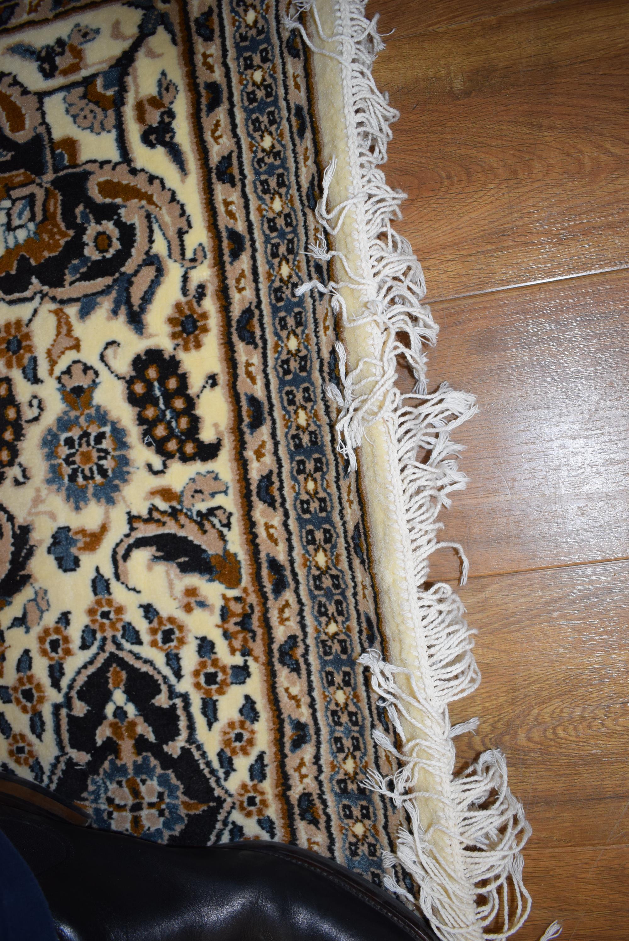 An Iranian carpet, the beige and blue ground with repeated diamond motifs, - Image 7 of 8