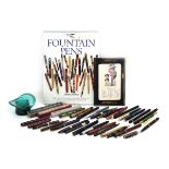 A group of thirty-one vintage pens and pencils including one with 9ct gold bands,