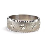 A 10ct white gold wedding band with star cut engraving on a matte ground, band w.