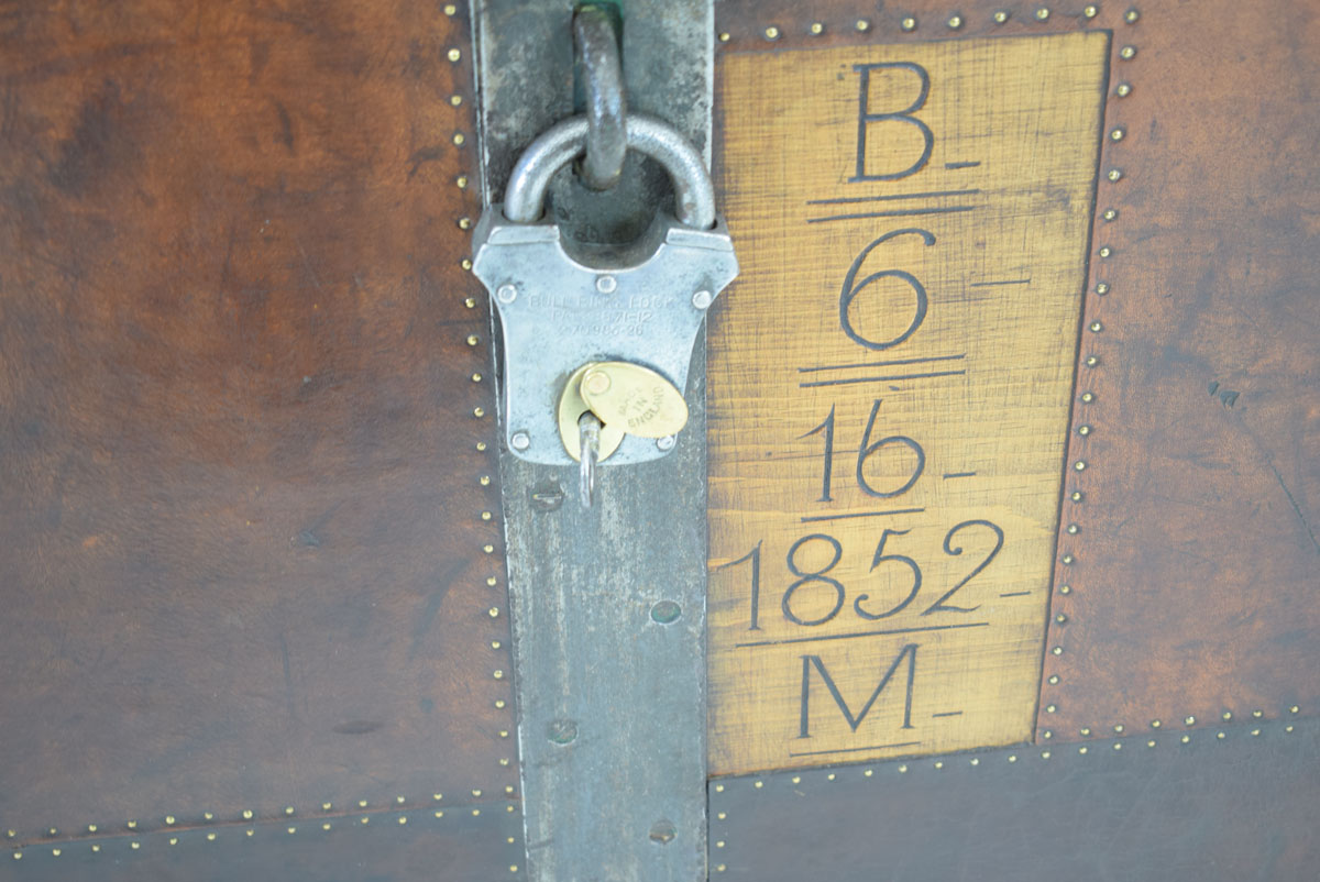 A 19th century metal bound trunk with leatherwork and brass studwork, the interior painted green, - Image 2 of 3