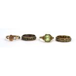 Four 9ct yellow gold and yellow metal rings including two eternity rings,