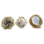 A 19th century gilt metal swivel brooch of oval form set two black and white photographic portraits