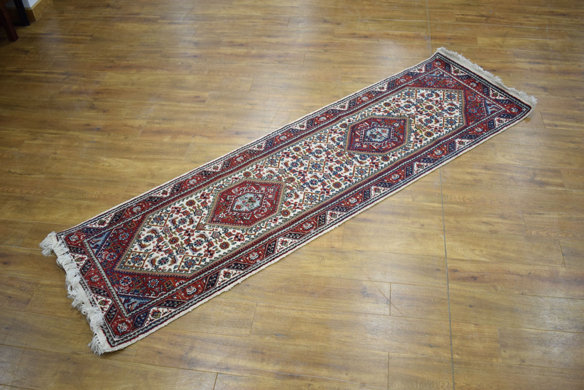 An Iranian carpet runner with a beige and red ground, - Image 2 of 2