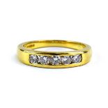 An 18ct yellow gold half eternity ring set five brilliant cut diamonds in a channel setting,