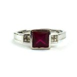 A 9ct white gold ring set square cut red coloured stone in a stepped setting,