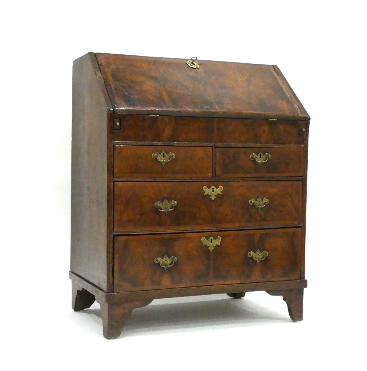 A George I/II walnut and feather crossbanded bureau, the fall front enclosing a fitted interior,