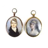 An 18th century gilt metal portrait miniature depicting a young gentleman wearing a white cravat,