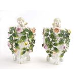 A pair of 19th century florally encrusted vases of ovoid form,