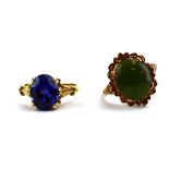 A 9ct yellow gold ring set oval vivid blue stone in a raised fleur de lis setting,