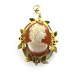 A 9ct yellow gold pendant of oval form inset a cameo depicting a female beauty head and shoulders,