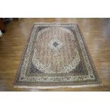 A 20th century carpet, the central medallion with a pale pink and sage ground,