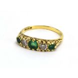 A 19th century-style 18ct yellow gold ring set three graduated emeralds and two brilliant cut