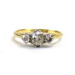 An early 20th century 18ct yellow gold and platinum highlighted ring set three graduated old cut