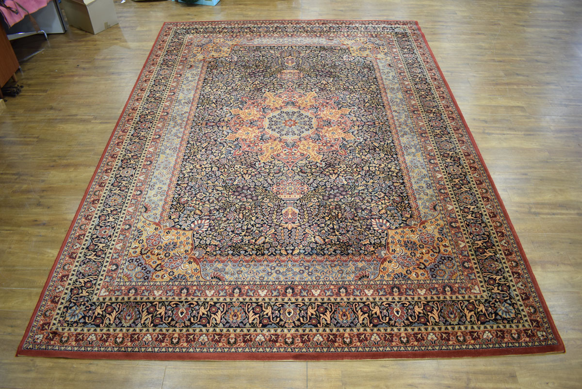 A 20th century carpet with a red ground and floral sprays,