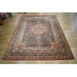 A 20th century carpet with a red ground and floral sprays,