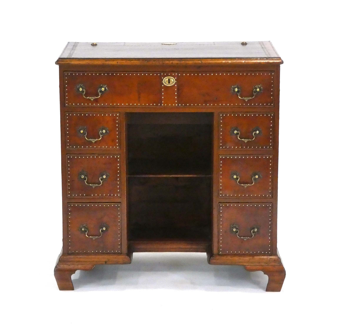 A Georgian mahogany knee-hole desk covered in leather with brass studwork and handles, on ogee feet,