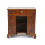 A Georgian mahogany knee-hole desk covered in leather with brass studwork and handles, on ogee feet,