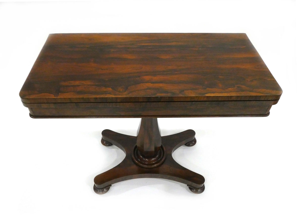 A Regency/William IV rosewood card table on a turned column with a platform base and bun feet, w. - Image 2 of 3