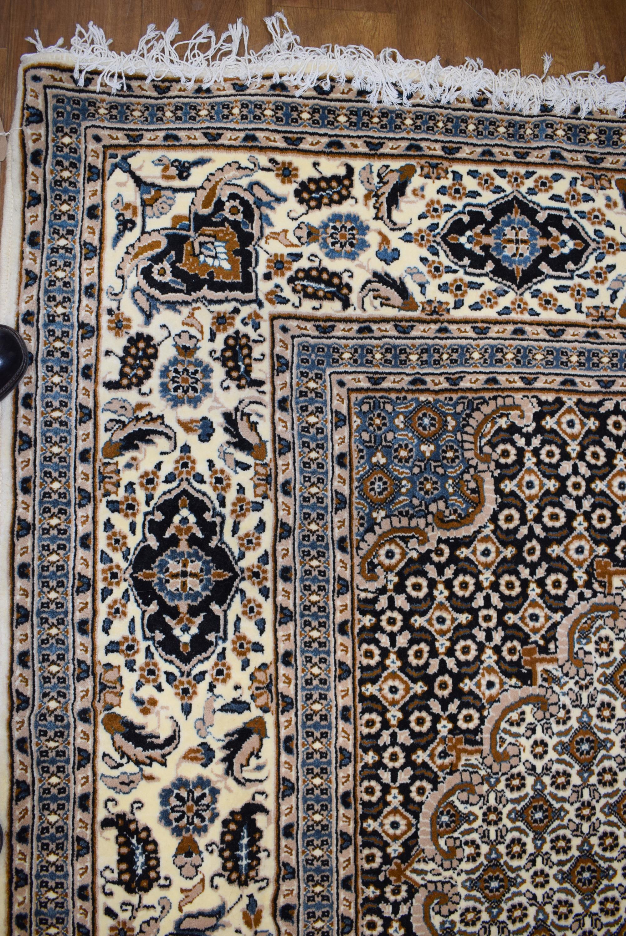 An Iranian carpet, the beige and blue ground with repeated diamond motifs, - Image 3 of 8