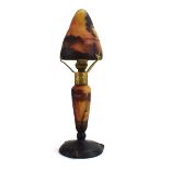A Daum Nancy cameo glass table lamp and cover of mushroom form decorated in the 'Red Sky' pattern