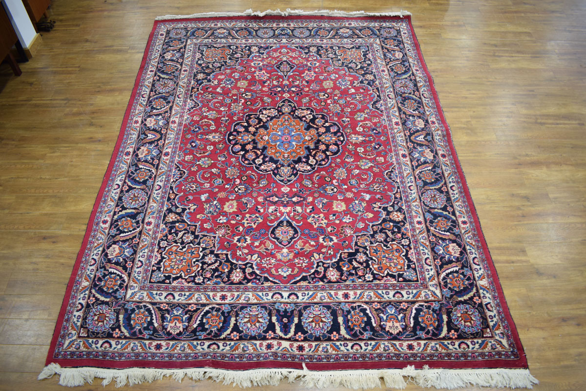 An Iranian carpet, the blue and floral ground within matching bands,