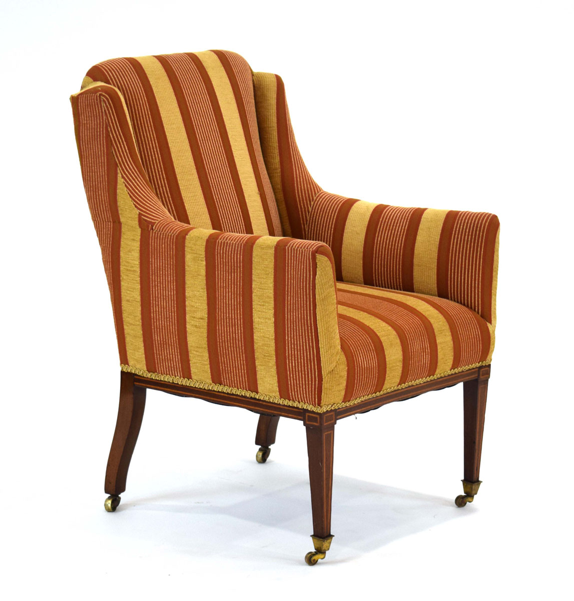 An Edwardian and later upholstered armchair with mahogany strung tapering legs on castors