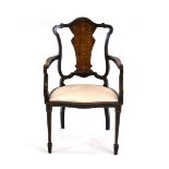 A late 19th century mahogany parlour armchair with a rosewood and marquetry splat,