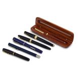 A Scheaffer fountain pen with a 14ct gold nib, two further pens with 14ct gold nibs,