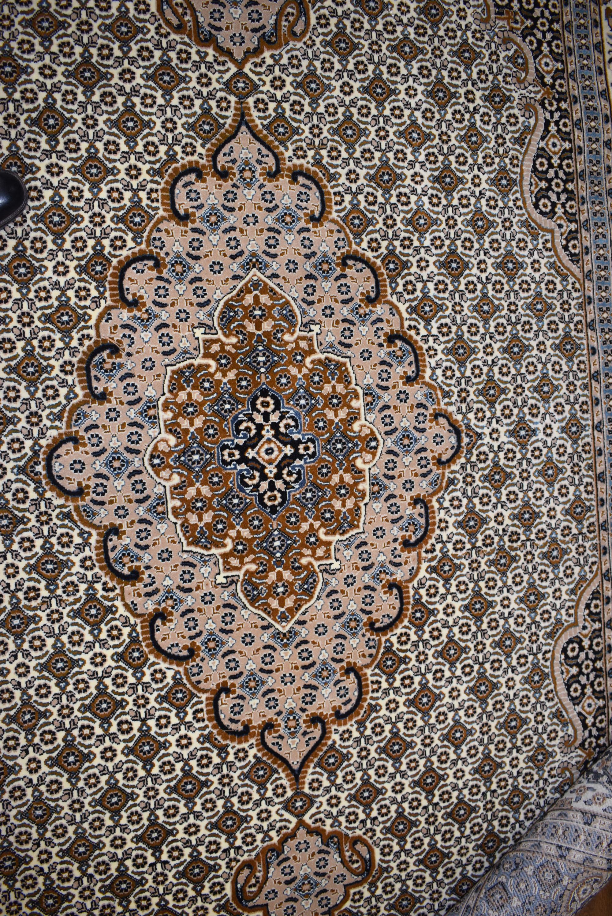 An Iranian carpet, the beige and blue ground with repeated diamond motifs, - Image 4 of 8