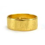A 22ct yellow gold wedding band with starburst engraving, maker MJ, London 1976, band w.