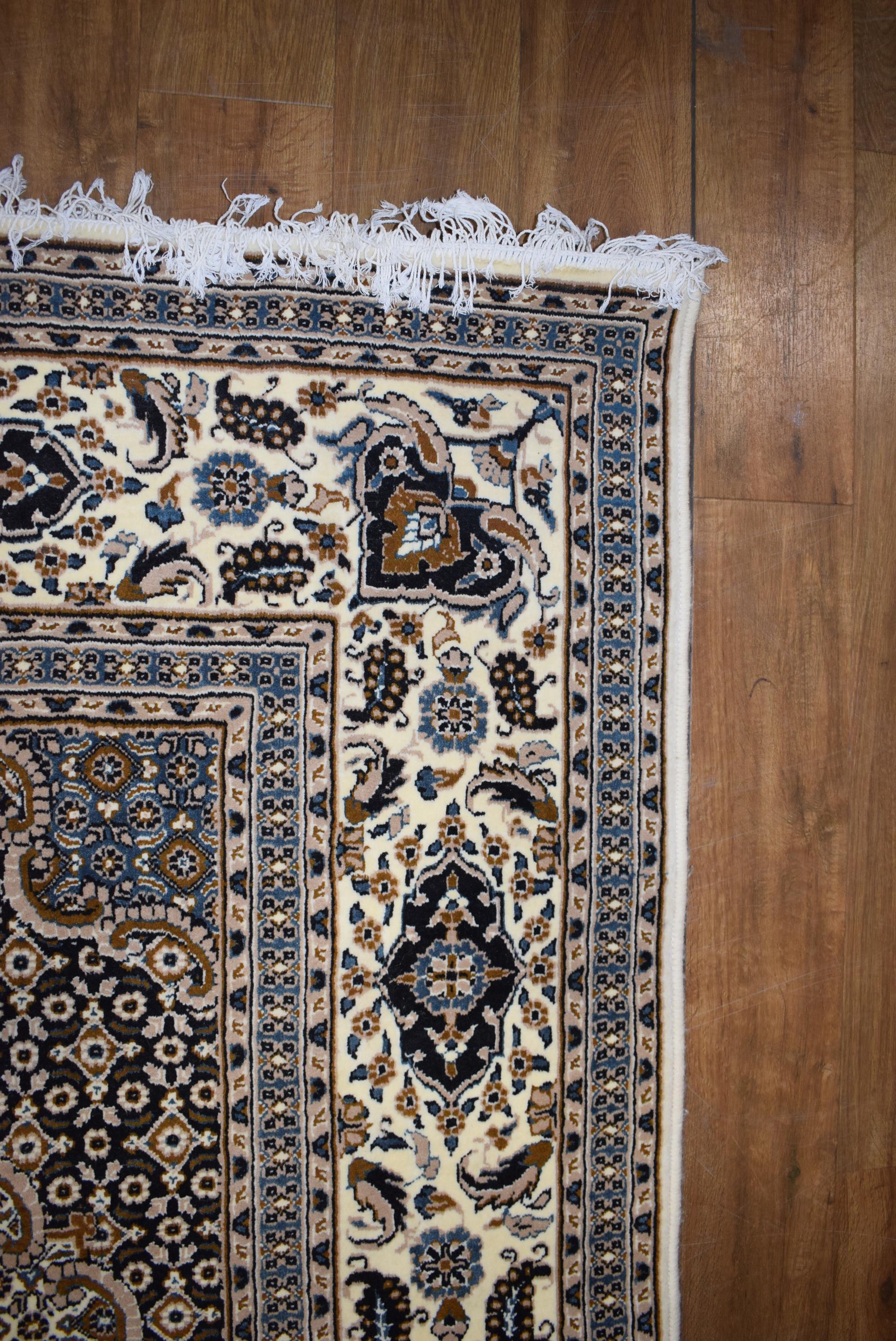 An Iranian carpet, the beige and blue ground with repeated diamond motifs, - Image 5 of 8