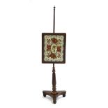 A Regency rosewood polescreen, the rectangular frame enclosing a floral tapestry,
