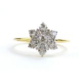 A 9ct yellow gold cluster ring set brilliant and baguette cut diamonds in a flowerhead setting by