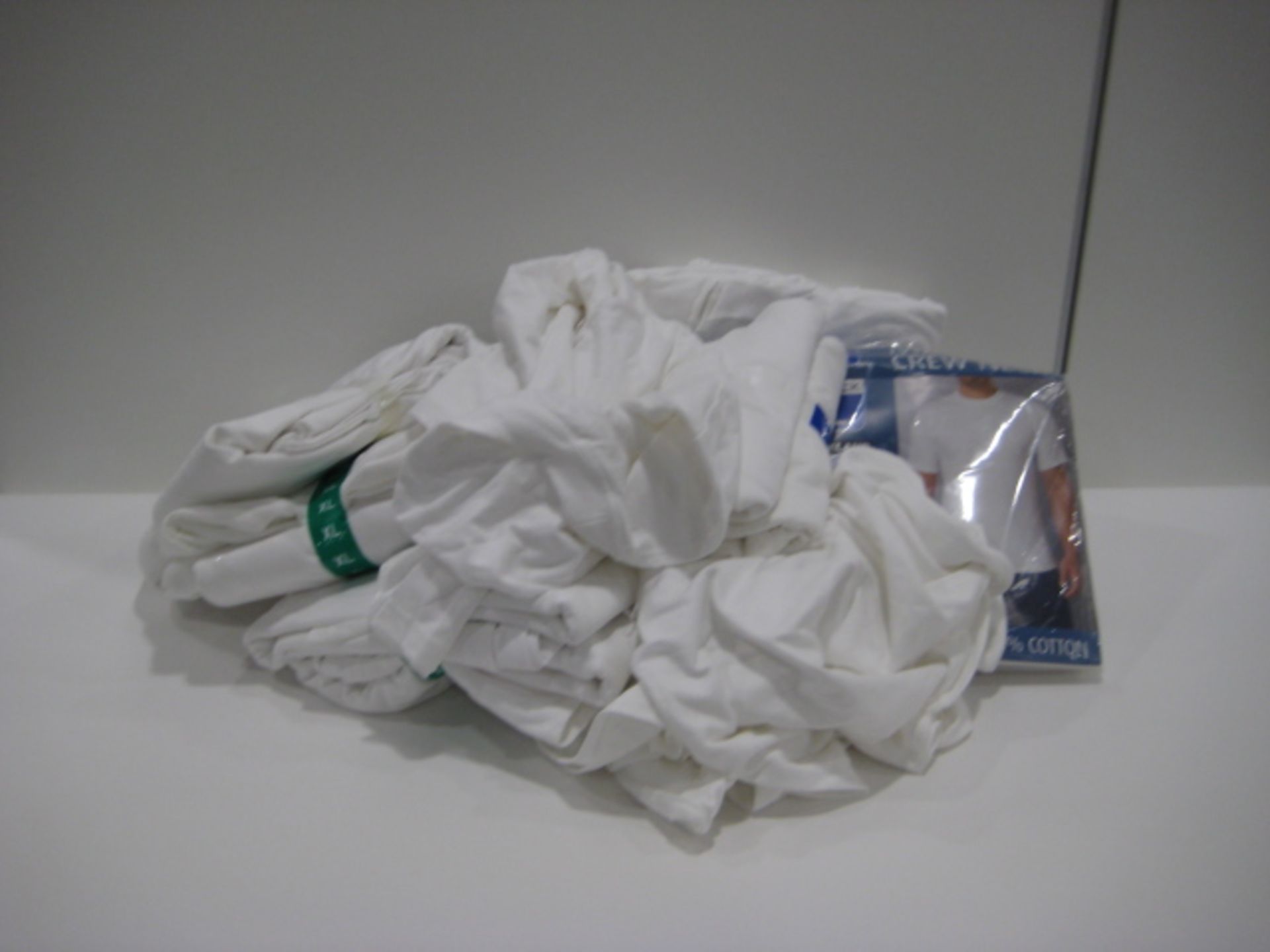 Bag containing gents white t-shirts mostly by Kirkland in sizes L and XL