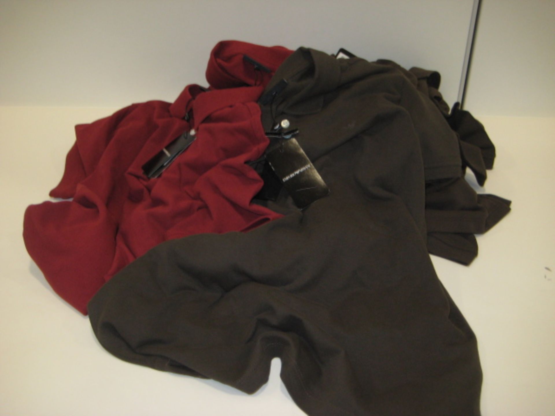 Bag containing 3 terracotta coloured Armani polo shirts (size M) and 7 Armani polo shirts in dark