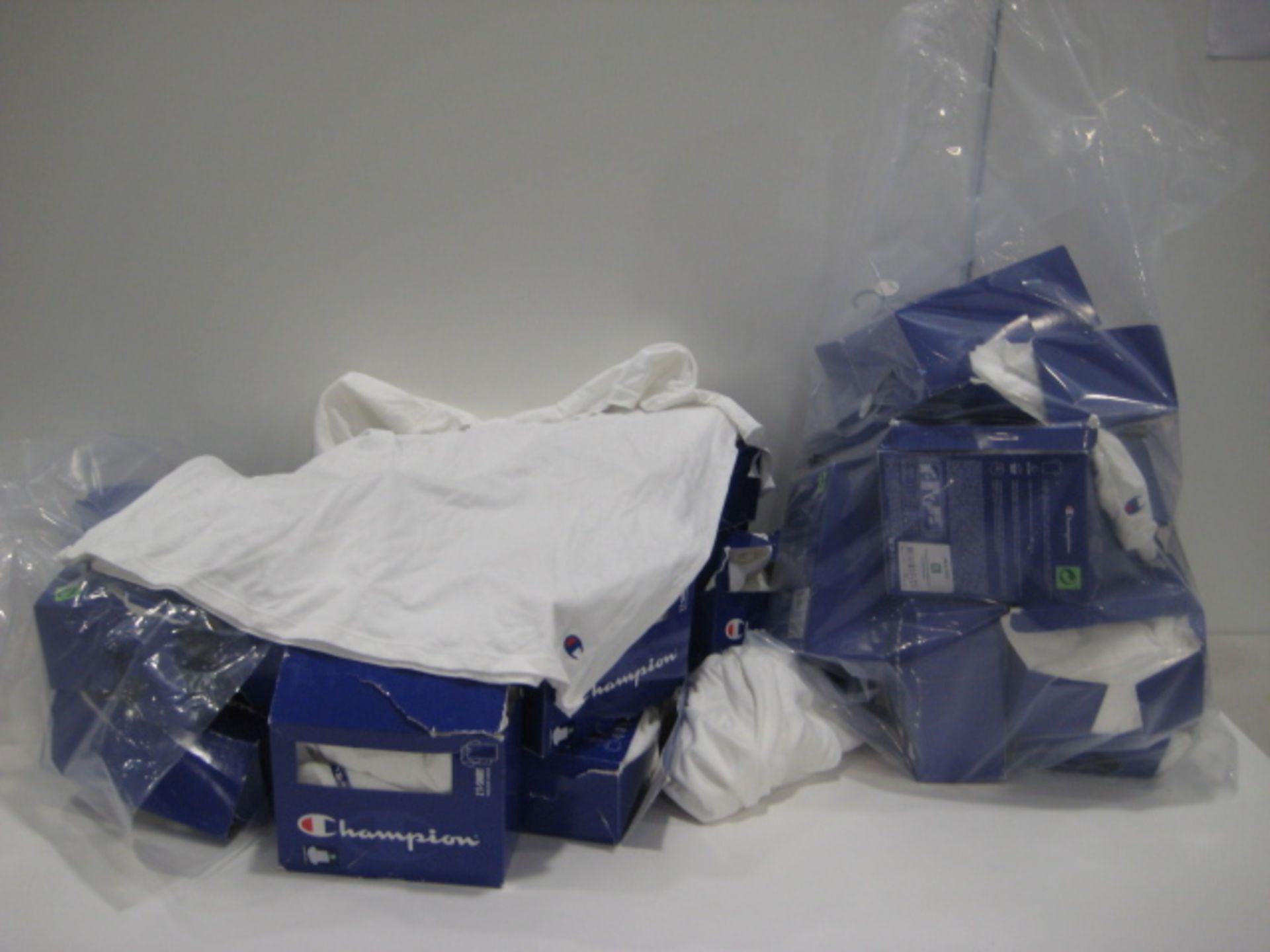 2 bags of Champion white t-shirts in various sizes