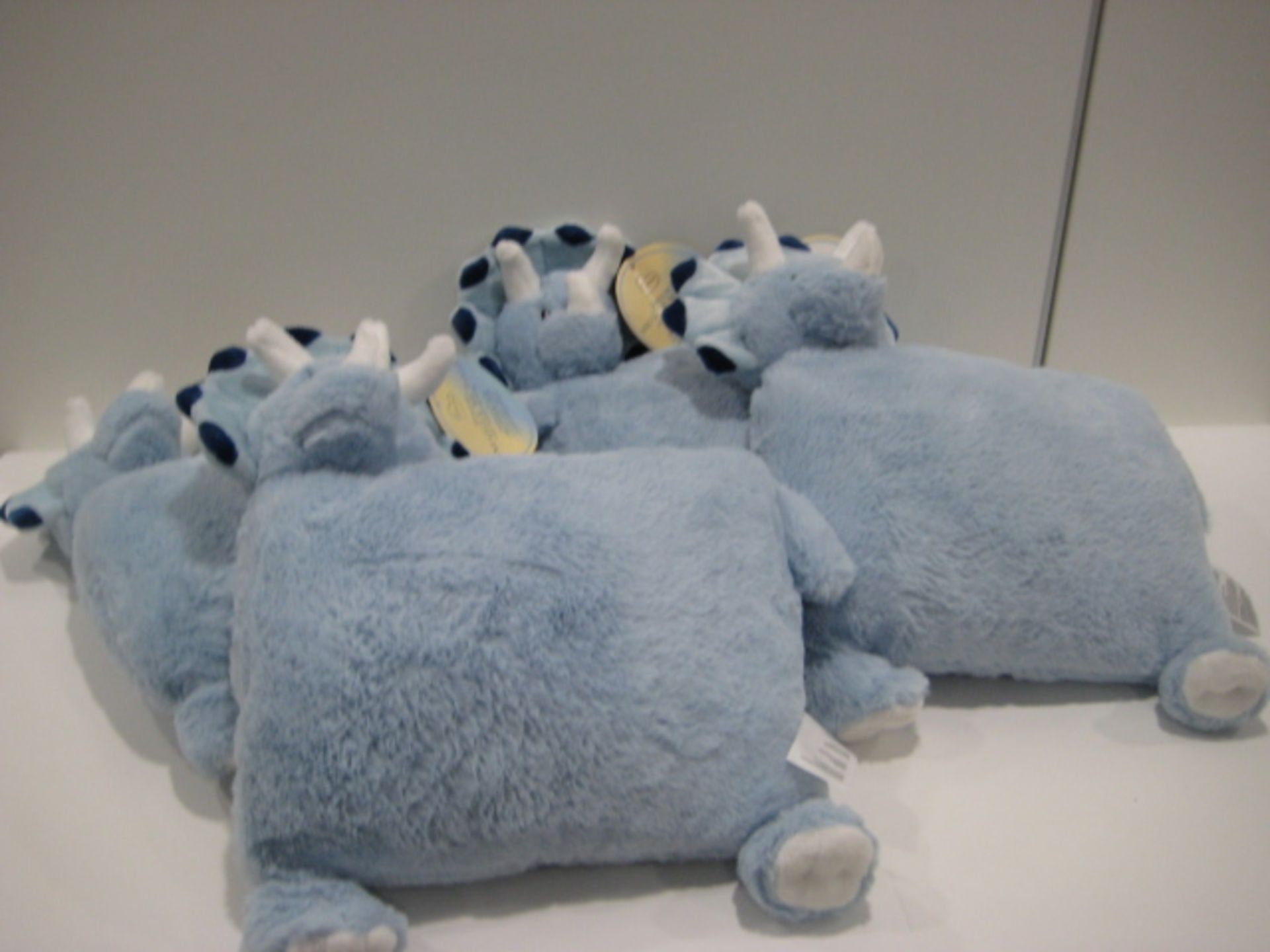 Bag containing 4 kiddies Snuggle Me Too blue dinosaur cushions