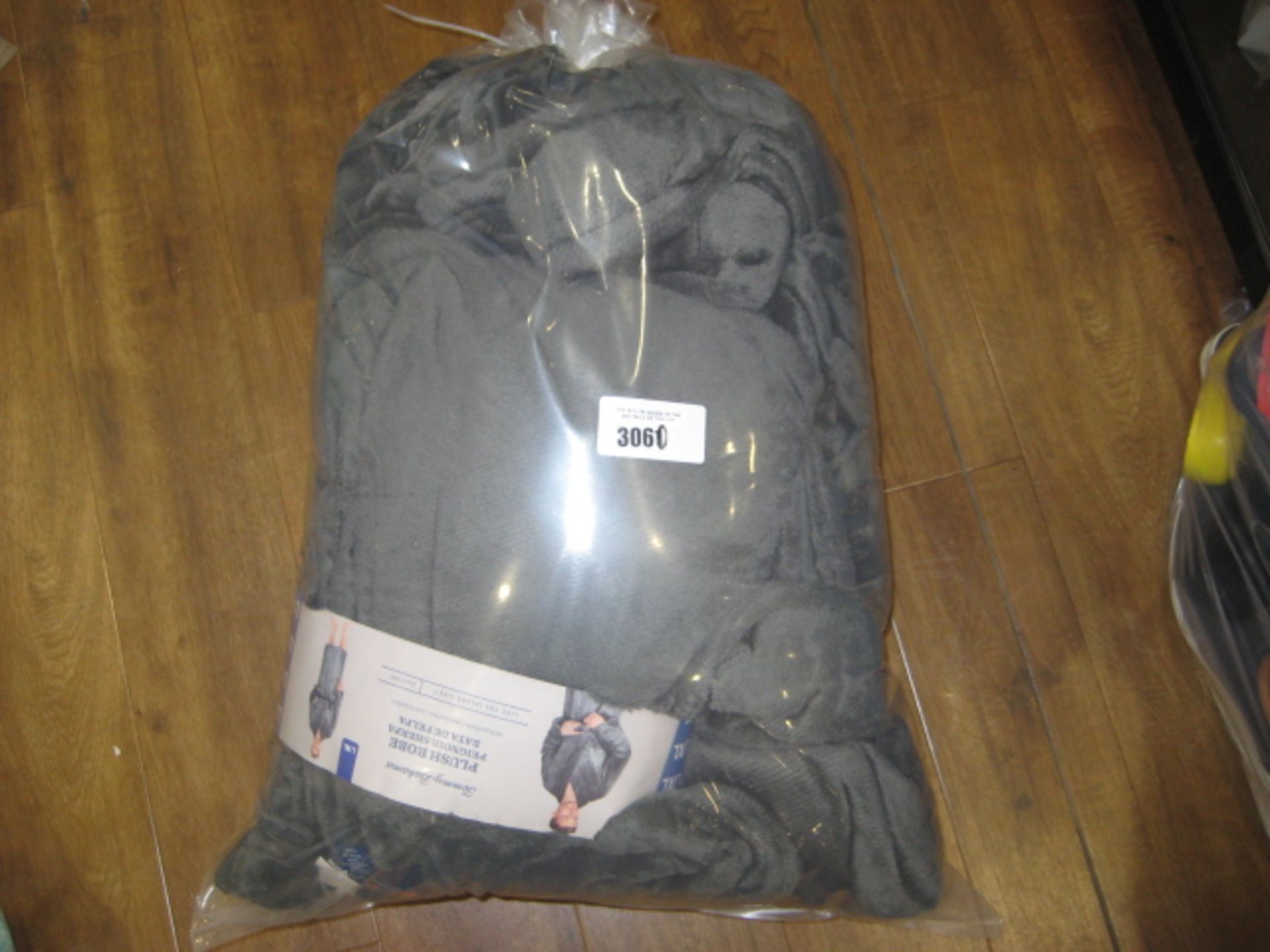 Bag containing Tommy Bahamas plush robes in grey