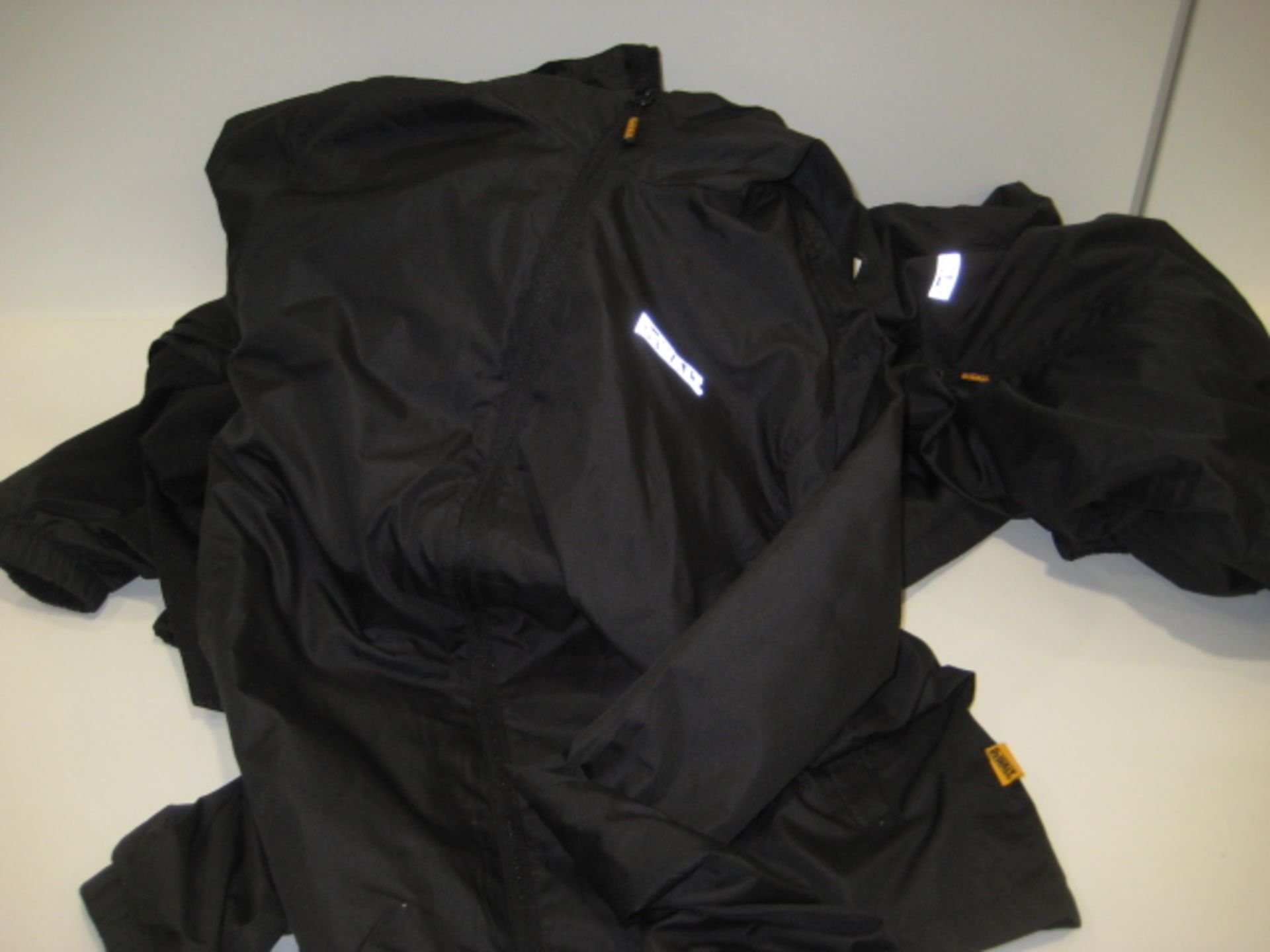 5 black DeWalt lightweight hooded jackets in black in sizes ranging from M - XXL