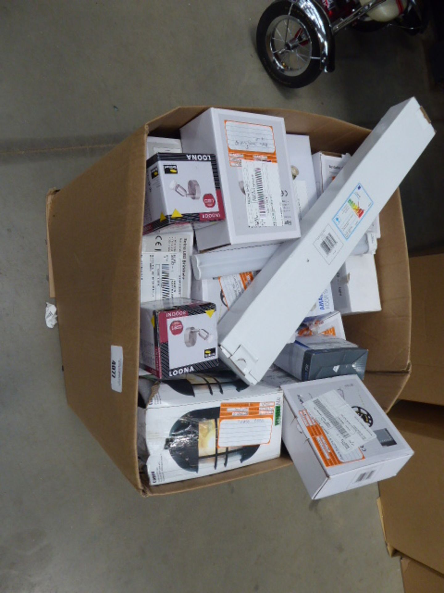 A large box containing strip lights, spotlights, wall lights, outdoor lights etc