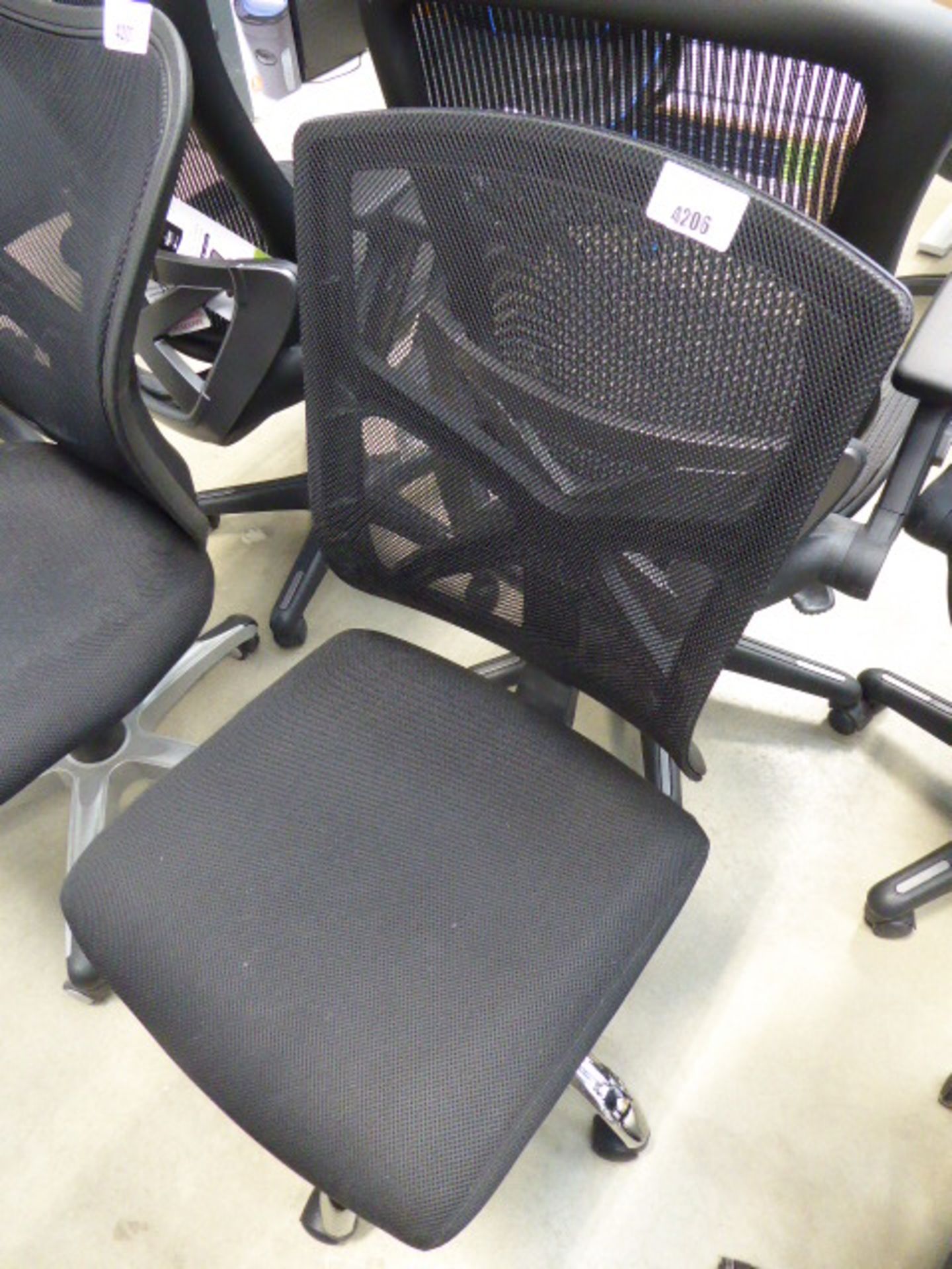 Black cloth mesh back swivel armchair