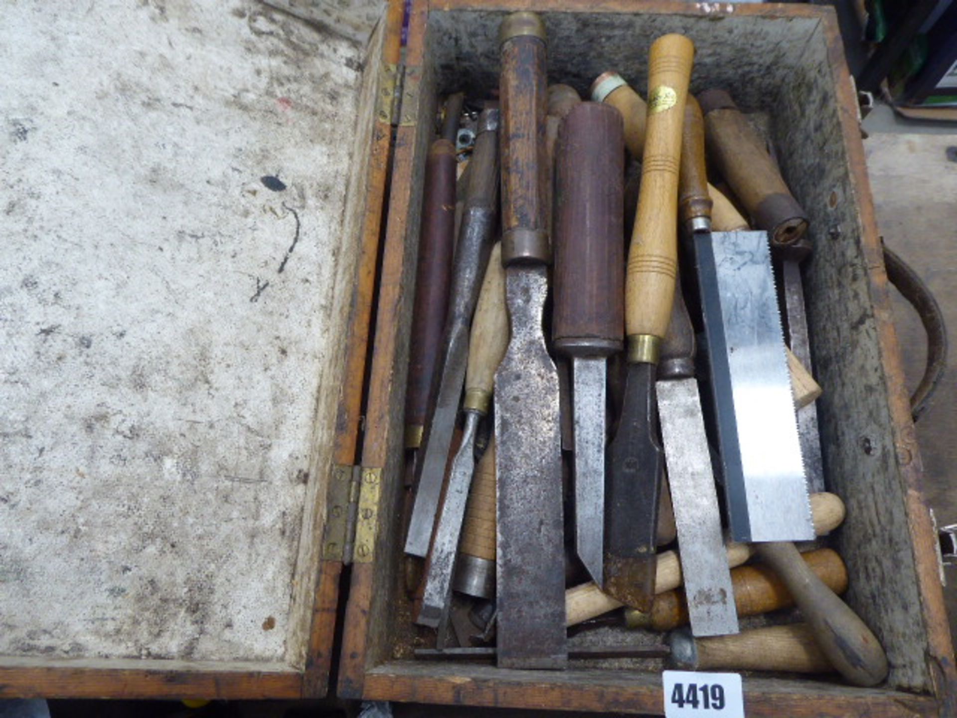 Wooden box containing wood turning chisels and dovetail saw