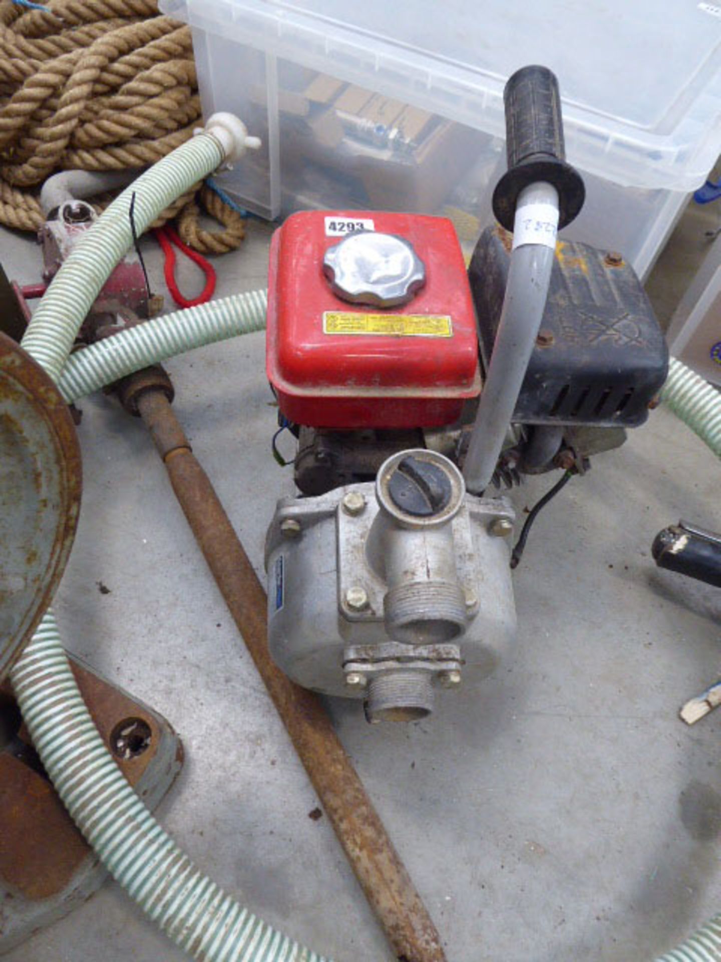 A petrol powered pump, hose and hand pump