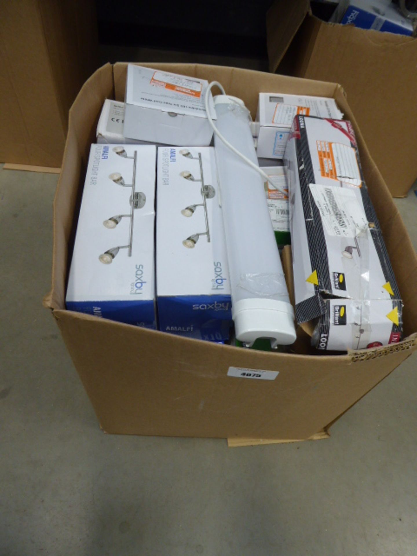 A large box containing strip lights, brick lights, ceiling lights, spotlights etc