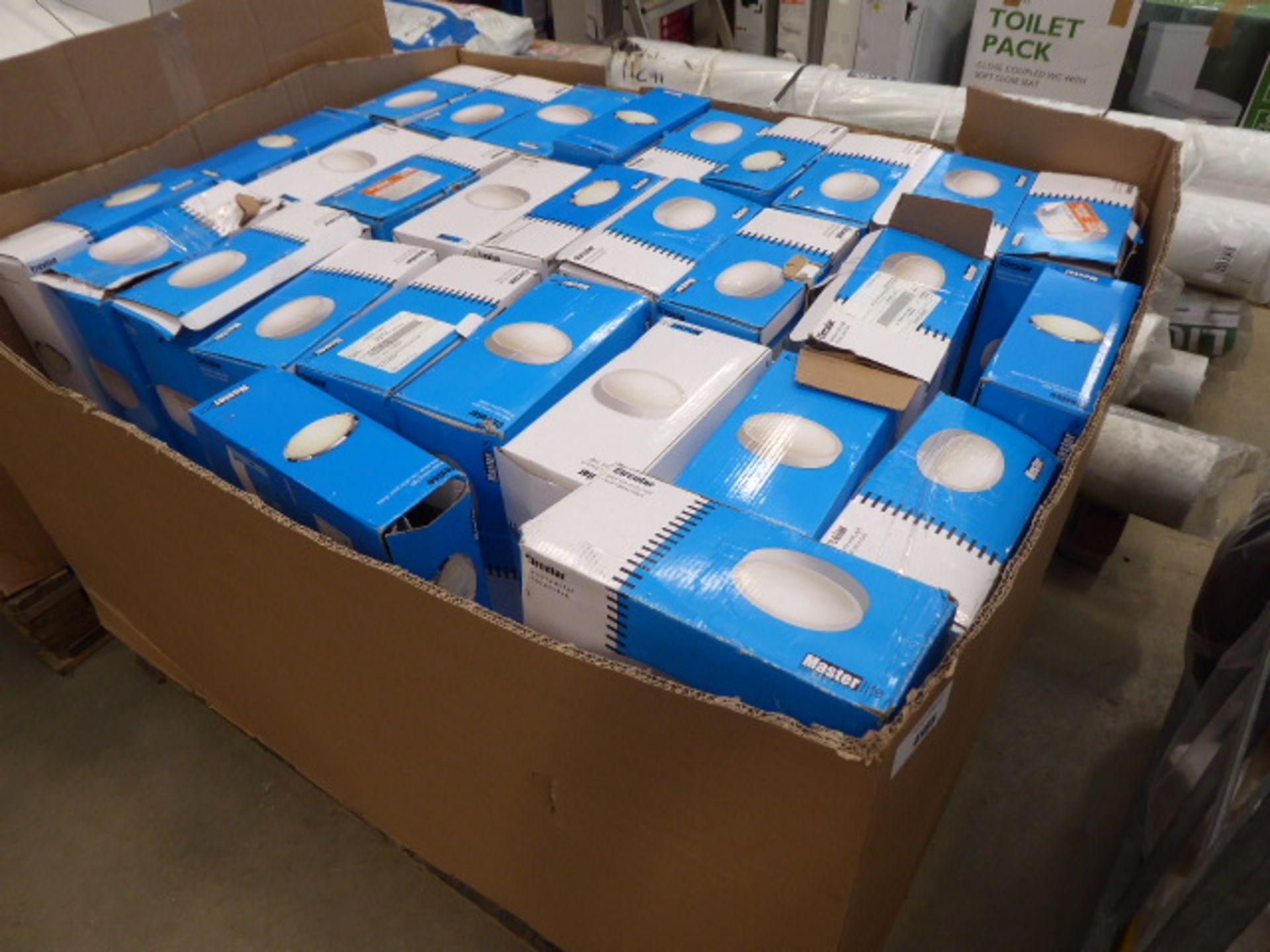 A large pallet box of circular bathroom ceiling lights