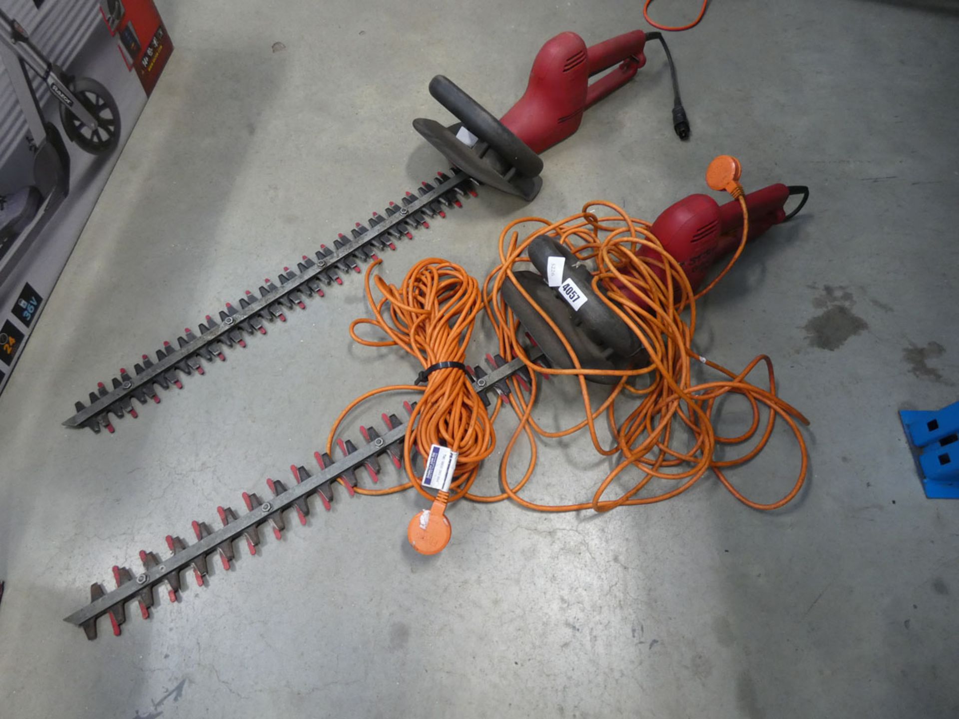 2 red electric hedgecutters